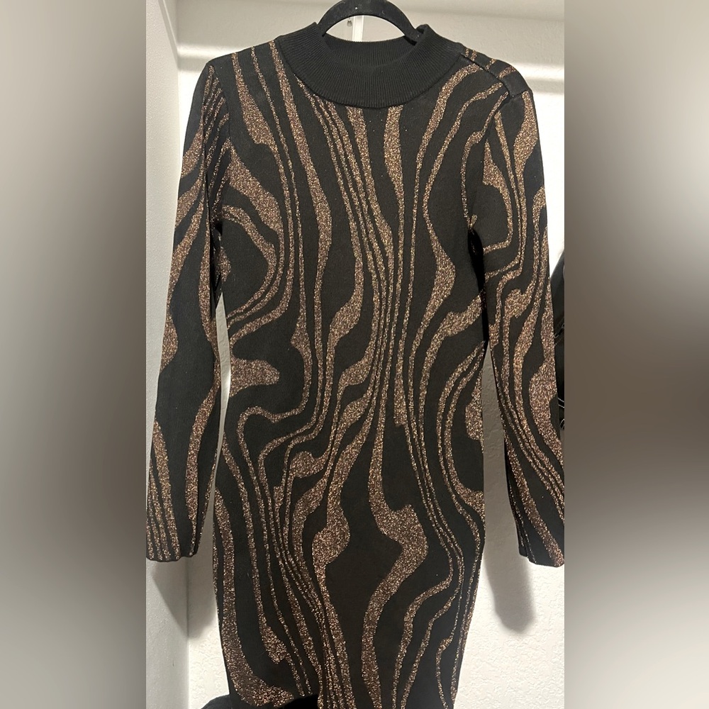 Black and gold sweater dress .